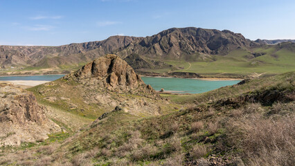 A beautiful wide river between rocks and hills in spring