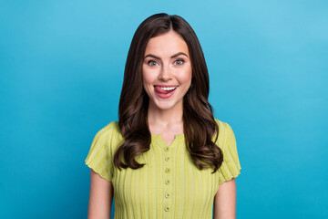 Fototapeta premium Photo of cute young brunette lady lick lip wear green t-shirt isolated on blue color background