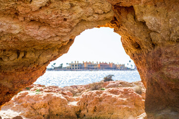 Fototapeta premium Beautiful sandstone arch with the view on marina in Portimao, Ferragudo, Algarve, Portugal