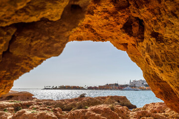 Beautiful sandstone arch with view on marina in Portimao, Ferragudo, Algarve, Portugal
