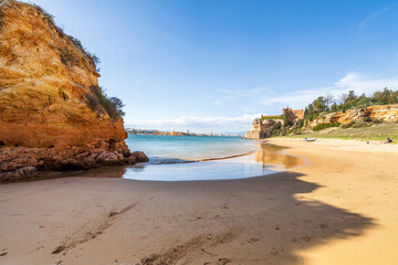 Coastline with sandy beach and castle in Ferragudo, Algarve, Portugal