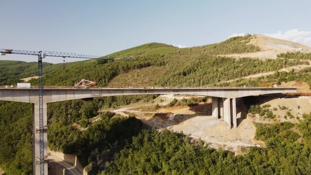 Highway bridge under construction. Aerial view of nes road. Freeway being built on a mountain terrain..