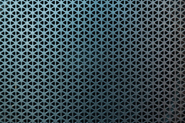 Protective black perforated mesh for music speakers.