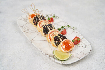Salmon lavash rolls with dill, cheese and black olives