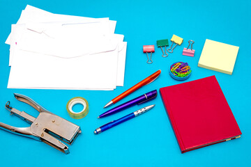 Office stationery objects on blue background