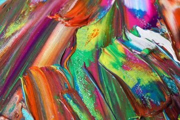 Strokes of colorful acrylic paints as background, closeup view