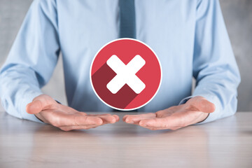 Hand holds icon,cancellation symbol,cancel icon.Cross mark flat red icon.round X mark.cancel...