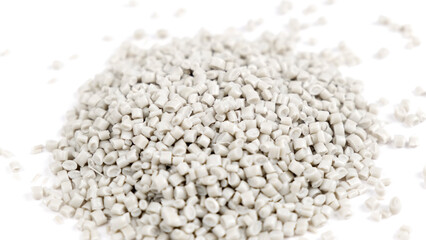 Secondary granule made of polypropylene, white Plastic pellets crumbles to the table. Plastic raw materials in granules for industry. Polymer resin. Raw plastic recycling concept