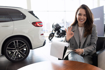 a young woman bought and insured her new car at a car dealership