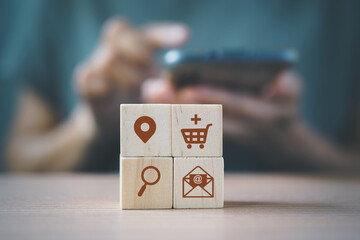 wooden cube blocks with buyer persona icons and blurred woman  for buyer persona and target customer concept. Personalized marketing. Customer analysis for marketing plan, online business strategy