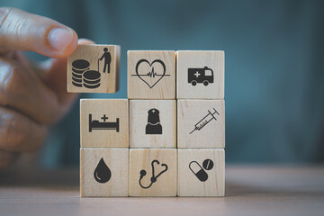 senior's hand holding wooden cube  block, elderly person and coins symbol,  health and medical symbol for health insurance ,elderly care, emergency case contact for aging or disabled people