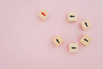 red arrow icon on wooden cube block out of the other black for leadership, outstanding, smart vision, new idea, business solution concept