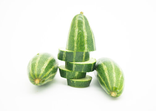 chopped and two whole pointed gourd isolated on white background