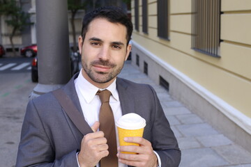 Fototapeta premium Good looking businessman holding coffee cup to go
