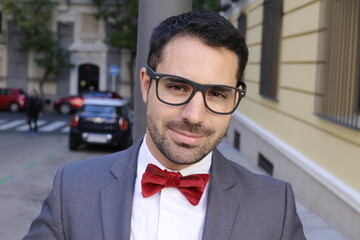 Charming man wearing tuxedo and elegant eyeglasses
