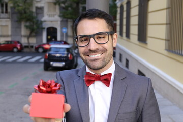 Handsome romantic man gifting with style