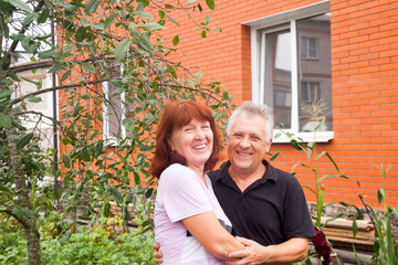 Elderly people are happy near   country house.