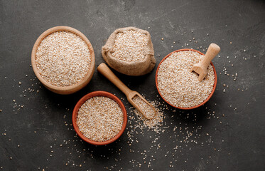 Barley groats in bowls and bags on a dark background. High quality photo