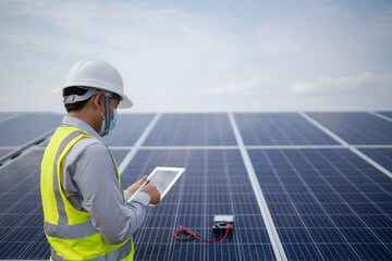 Young engineering working in the power station solar panel