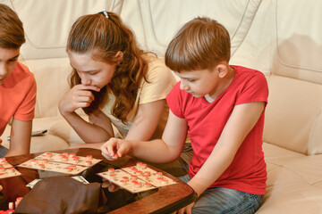 Little friends play loto game. Calm and friendly children play b