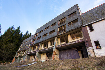 Old abandoned socialist communist hotel building without windows and doors in former Czechoslovakia