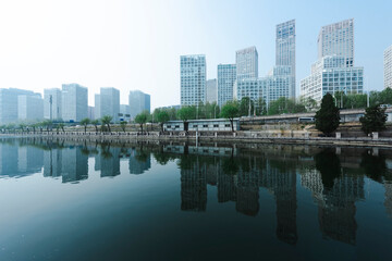 Obraz na płótnie Canvas City buildings are reflected on the river