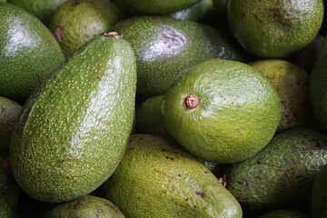 stacked avocado fruits, close up