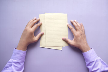 Obraz premium top view of mens hand on blank paper on table 