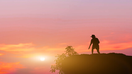 Silhouette people standing on mountain sunset background