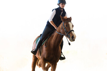 Obraz premium Young girl riding a horse