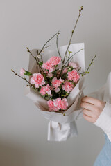 Wedding bouquet of flowers for the bride in female hands. White peonies