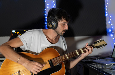 Obraz premium male composer with guitar in recording studio
