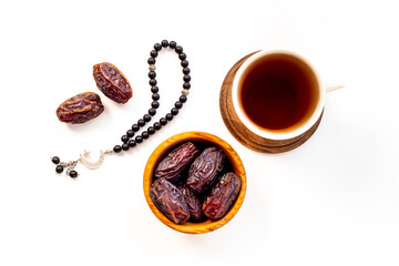 Islamic rosary with dates and tea. Ramadan Kareem concept.
