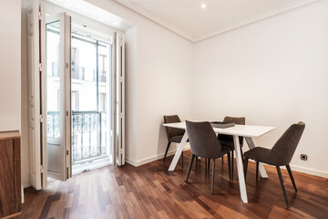 Naklejka na ściany i meble Dining room with white wooden table with vintage bay window balcony a mahogany oak parquet flooringd