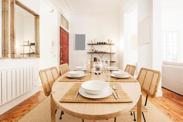 Dining table in natural color with matching fiberglass mesh chairs and pine wood flooring