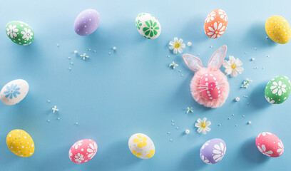 Fototapeta na wymiar Happy easter! colourful Easter eggs with flower on pastel blue background.