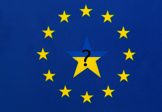 Star in the color of the Ukrainian flag and a question mark in the center of the flag of the European Union. Concept of Ukraine's accession to the EU.