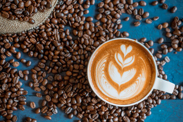 coffee latte art on wood table, relax time, cafe barista art top view.