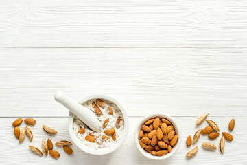 Pestle almond flour - nuts with mortar on kitchen table
