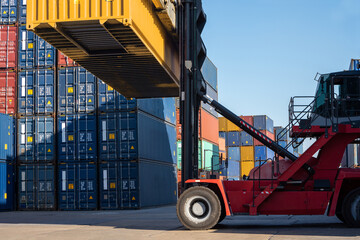 forklift working in the container cargo yard port loading cargo tank  logistic service and transportation concept. © Yellow Boat