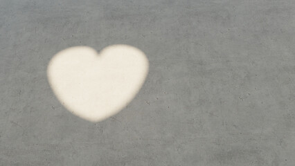 Obraz premium heart symbol shaped light and shadow on concret floor, 3d rendering