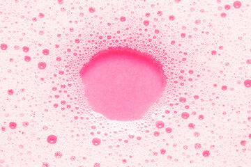 Pink soap bubbles on the water, empty space for text.