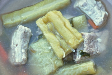boiled bitter cucumber with pork bone in clear soup on bowl
