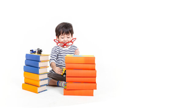 little boy wearing glasses with books on white background, education concept.