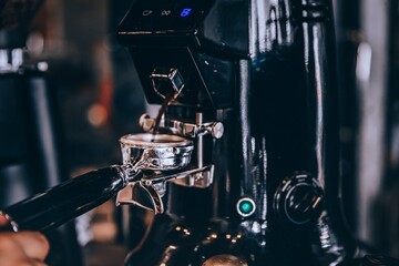 Barista making coffee with coffee machine in cafe.