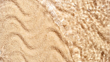 Water flows down from the top of handful of brown sugar flooding it | Background shot for body scrub commercial
