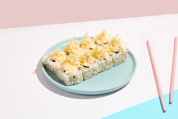 Cheese maki roll on blue ceramic plate. Sushi roll in Caesar style on coloured backdrop. Sushi menu concept. Modern japanesse food. Maki sushi with cheese in minimal style