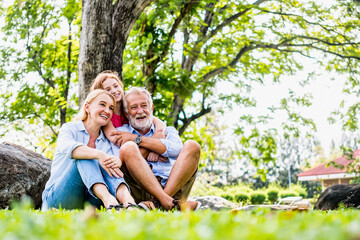 Happy family parent and child relax in weekend holiday lifestyle park outdoor nature background.