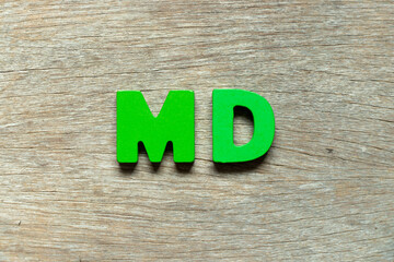 Color alphabet letter in word MD (abbreviation of doctor of medicine or managing director) on wood...