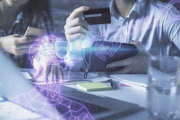 Double exposure of man and woman on-line shopping holding a credit card and human in AR glasses hologram drawing. Virtual reality Education E-commerce concept.